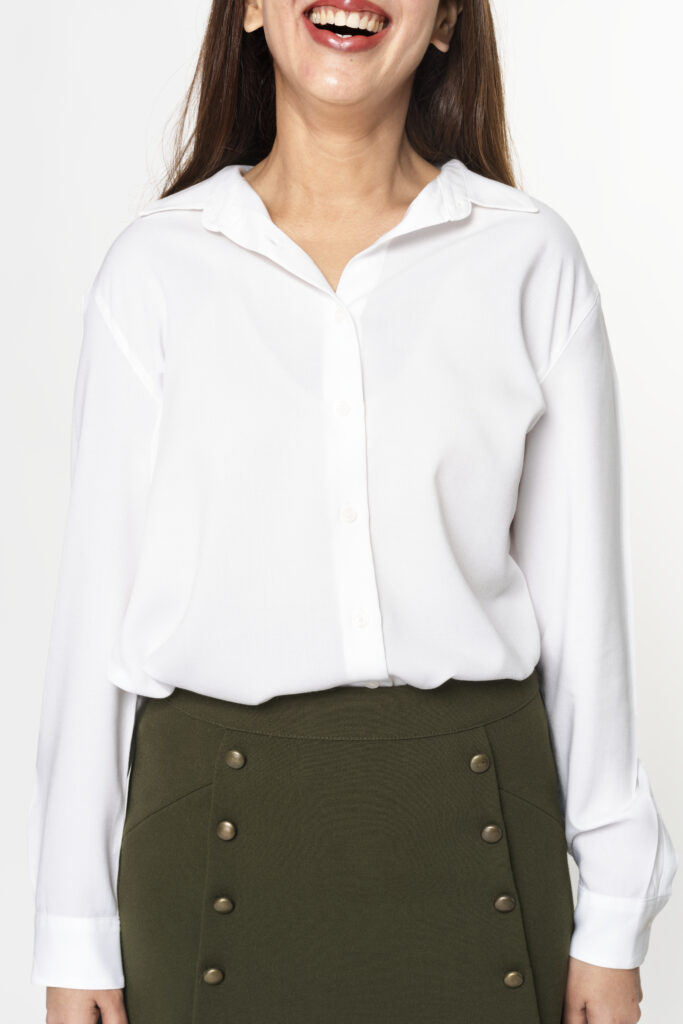 Woman wearing white long-sleeve shirt with green skirt